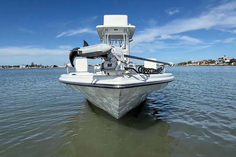  Yacht Photos Pics 2024 East Cape 25 Hybrid boat on calm water under clear blue sky.