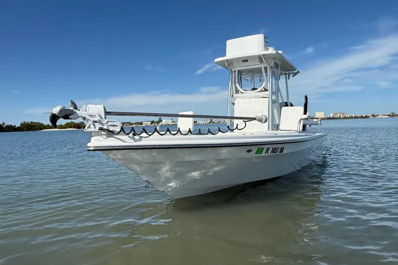  Yacht Photos Pics 2024 East Cape 25 Hybrid boat on calm water under clear blue sky.