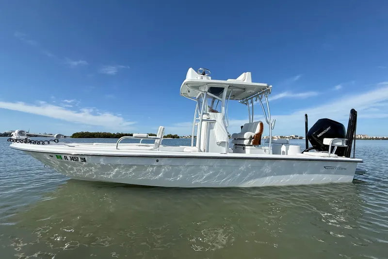  Yacht Photos Pics 2024 East Cape 25 Hybrid boat on calm water under clear blue sky.