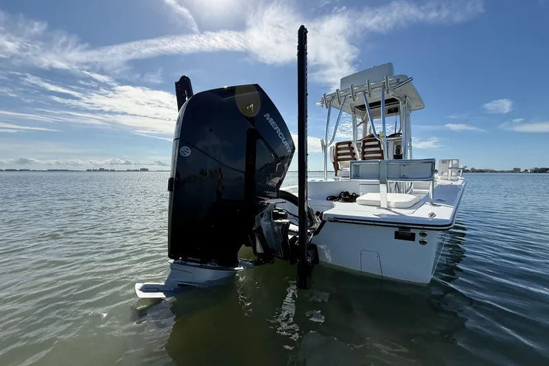  Yacht Photos Pics 2024 East Cape 25 Hybrid boat with Mercury engine in calm waters under blue sky.