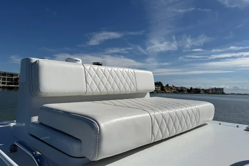  Yacht Photos Pics 2024 East Cape 25 Hybrid boat seat with quilted white upholstery, overlooking serene water.