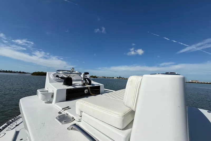  Yacht Photos Pics 2024 East Cape 25 Hybrid boat on calm water under clear blue sky.