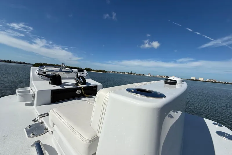  Yacht Photos Pics 2024 East Cape 25 Hybrid boat on calm water under clear blue sky.