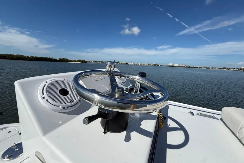  Yacht Photos Pics 2024 East Cape 25 Hybrid boat steering wheel with scenic water view.