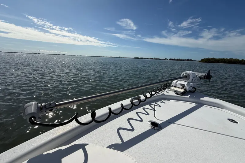  Yacht Photos Pics 2024 East Cape 25 Hybrid boat on calm waters under a clear blue sky.
