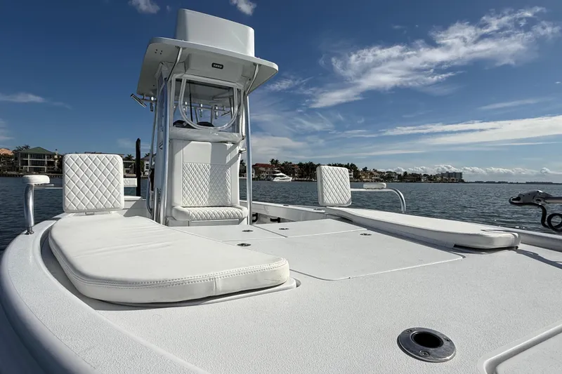  Yacht Photos Pics 2024 East Cape 25 Hybrid boat on water, featuring sleek white design and comfortable seating.