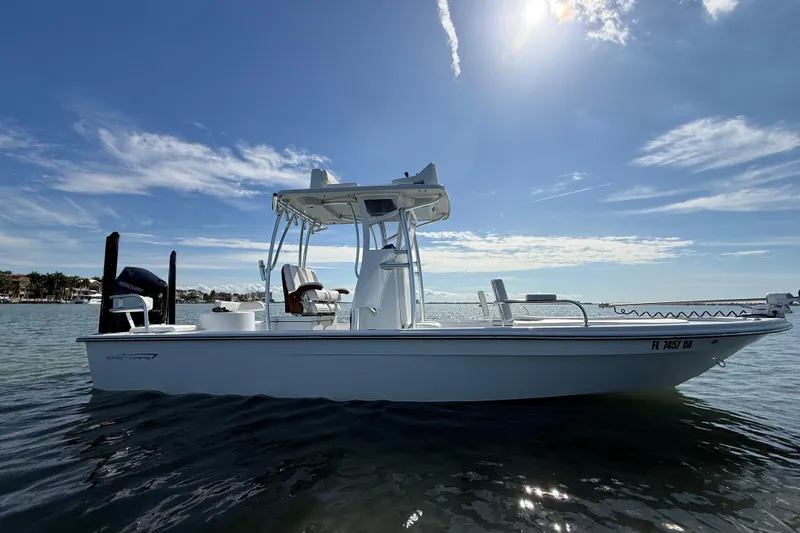  Yacht Photos Pics 2024 East Cape 25 Hybrid boat on calm water under a sunny sky.