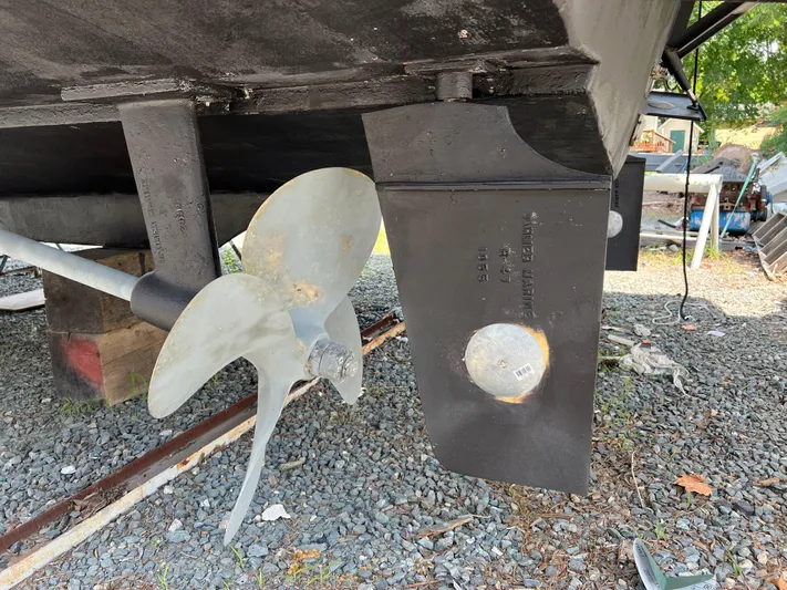 Amities Yacht Photos Pics Propeller and rudder of a 1998 Mainship 47 Motor Yacht on gravel.