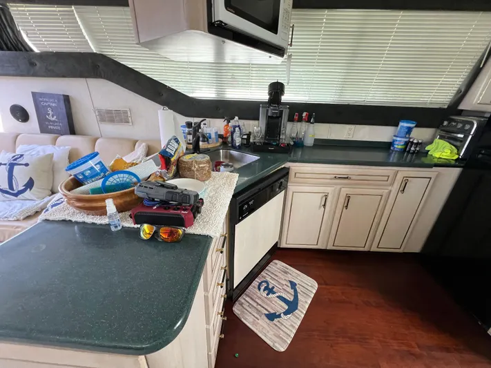 Amities Yacht Photos Pics Interior of 1998 Mainship 47 Motor Yacht kitchen with countertop and appliances.