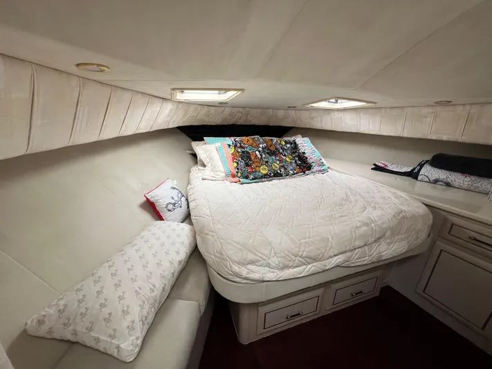 Amities Yacht Photos Pics Cozy bedroom interior of 1998 Mainship 47 Motor Yacht with plush bedding and decorative pillows.