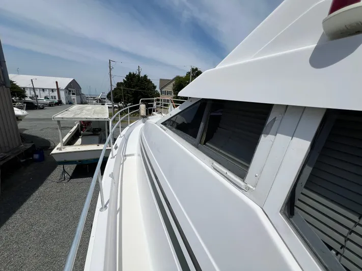 Amities Yacht Photos Pics 1998 Mainship 47 Motor Yacht docked, showcasing sleek design and spacious deck.