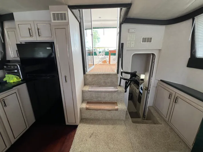 Amities Yacht Photos Pics Interior of 1998 Mainship 47 Motor Yacht with stairs and kitchen area.