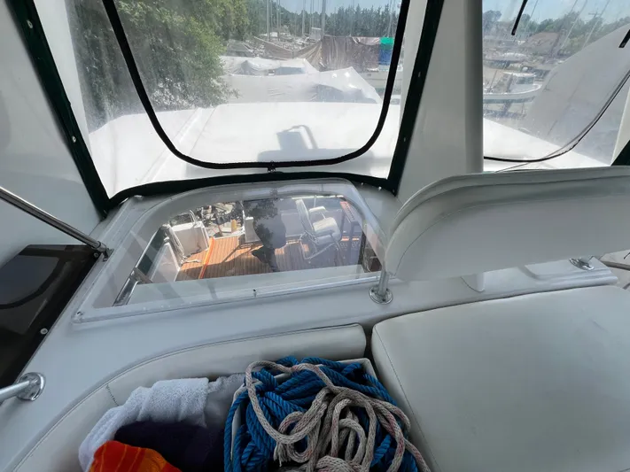 Amities Yacht Photos Pics 1998 Mainship 47 Motor Yacht interior view with ropes and towels on seating area.