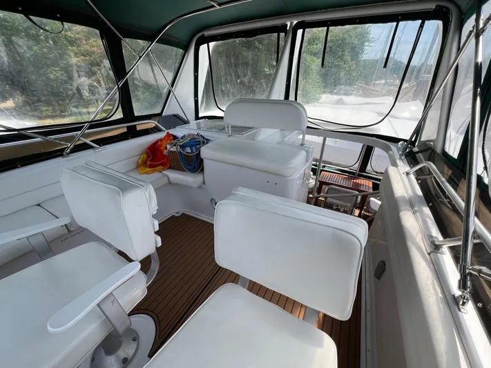 Amities Yacht Photos Pics 1998 Mainship 47 Motor Yacht interior with white seating and wooden flooring.