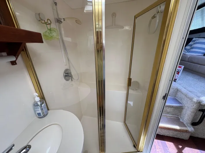 Amities Yacht Photos Pics Bathroom interior of 1998 Mainship 47 Motor Yacht with shower and sink.