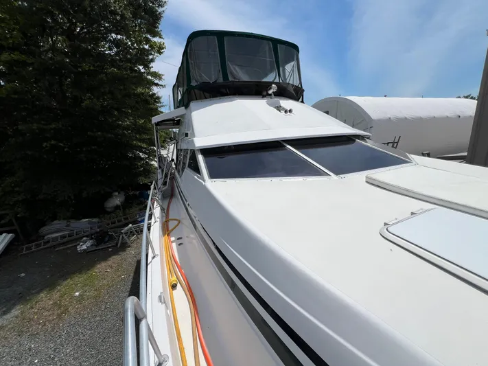 Amities Yacht Photos Pics 1998 Mainship 47 Motor Yacht docked, featuring sleek design and spacious deck area.
