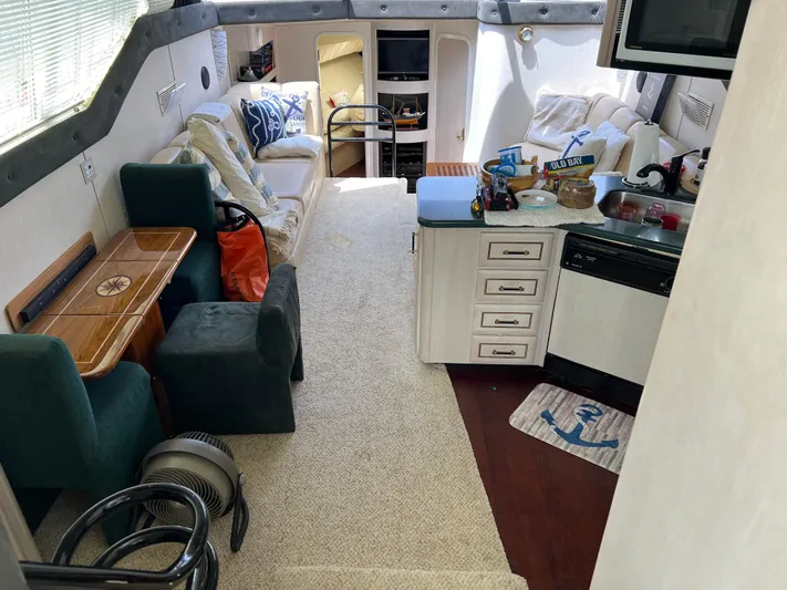 Amities Yacht Photos Pics Interior of a 1998 Mainship 47 Motor Yacht with cozy seating and kitchen area.