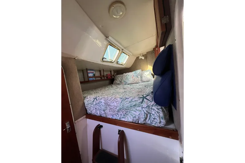 Sea Change Yacht Photos Pics Cozy cabin interior of 2003 Endeavour 36 TrawlerCat with bed and porthole windows.