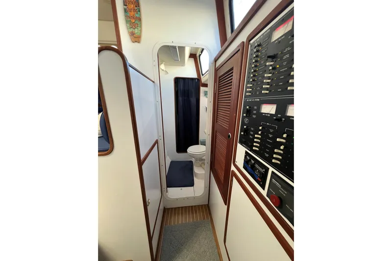 Sea Change Yacht Photos Pics Interior of 2003 Endeavour 36 TrawlerCat showing control panel and compact bathroom.
