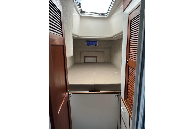 Sea Change Yacht Photos Pics Cabin interior of 2003 Endeavour 36 TrawlerCat with bed and wooden doors.