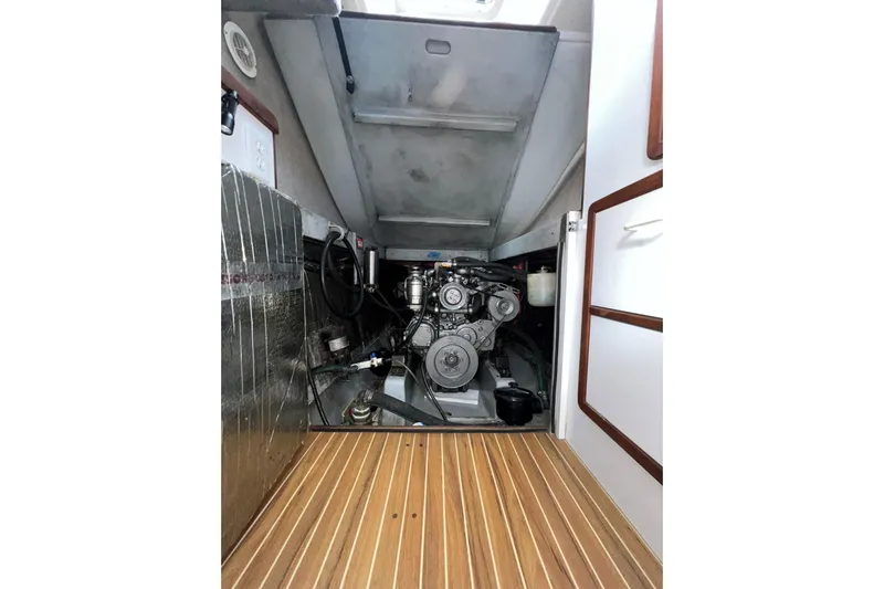 Sea Change Yacht Photos Pics Engine room of 2003 Endeavour 36 TrawlerCat with visible machinery and wooden flooring.