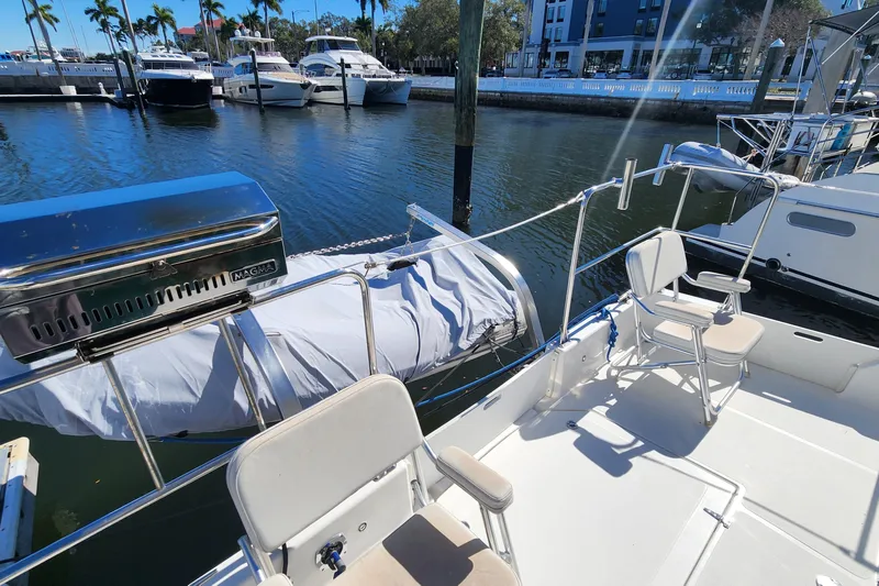Sea Change Yacht Photos Pics 2003 Endeavour 36 TrawlerCat with deck chairs and grill, docked at marina.