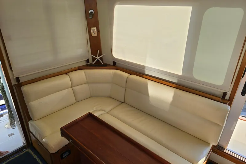 Lindy Yacht Photos Pics Luxurious interior of 2004 Legacy Yachts Sedan Flybridge with cream seating and wooden accents.