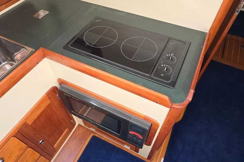 Lindy Yacht Photos Pics 2004 Legacy Yachts Sedan Flybridge kitchen with stove and microwave.