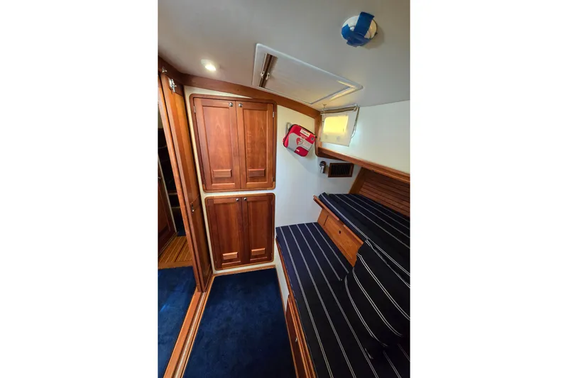 Lindy Yacht Photos Pics 2004 Legacy Yachts Sedan Flybridge interior with wooden cabinets and striped seating.