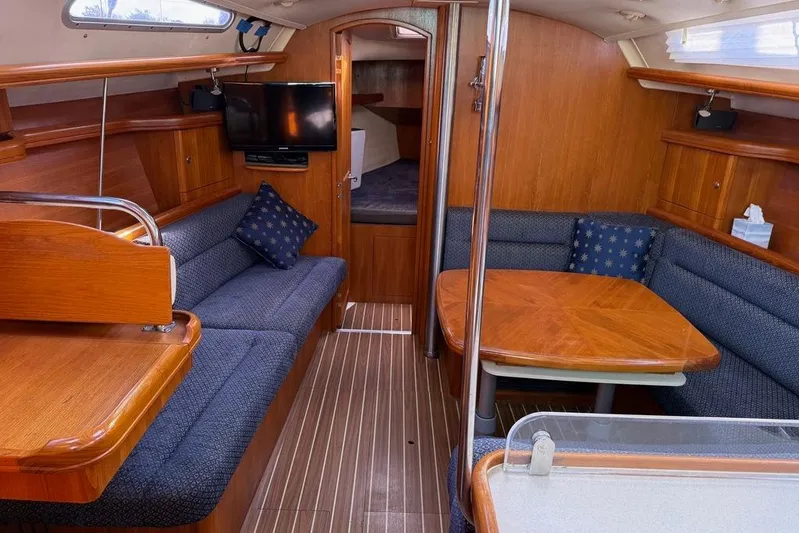 Windependence Yacht Photos Pics Interior of 2006 Hunter 38 sailboat with wood finish and cozy seating area.