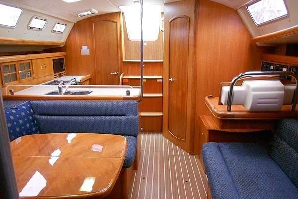 Windependence Yacht Photos Pics Interior of a 2006 Hunter 38 sailboat with wood finish and blue seating.