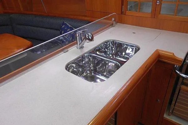 Windependence Yacht Photos Pics Modern kitchen sink in 2006 Hunter 38 yacht with wooden cabinetry.