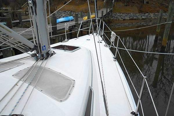 Hunter 38 sailboat deck, 2006 model, docked with visible rigging and hatch.