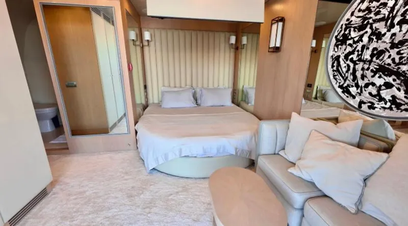  Yacht Photos Pics Luxurious bedroom interior on 2007 Riva 115 Athena yacht, featuring elegant decor and comfortable seating.