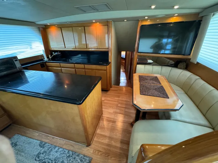 Whiskey Business Yacht Photos Pics Luxurious interior of 2000 Viking 58 Enclosed yacht with modern kitchen and dining area.