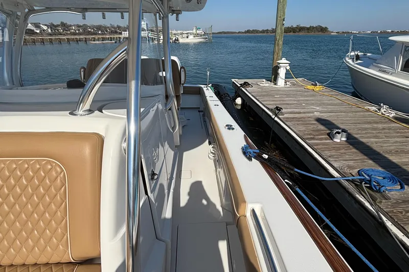  Yacht Photos Pics 2020 Valhalla Boatworks V-33 docked, featuring tan seating and sleek design.
