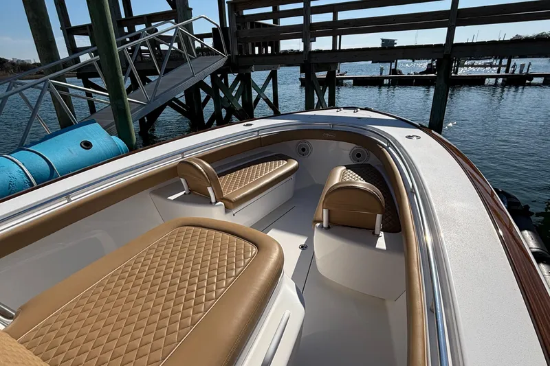  Yacht Photos Pics 2020 Valhalla Boatworks V-33 with tan seating, docked by wooden pier.
