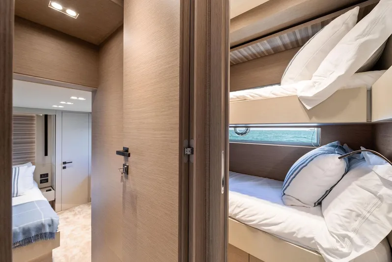 Giulia Yacht Photos Pics Luxurious interior of 2023 Ferretti Yachts 670 featuring cozy bunk beds and elegant design.