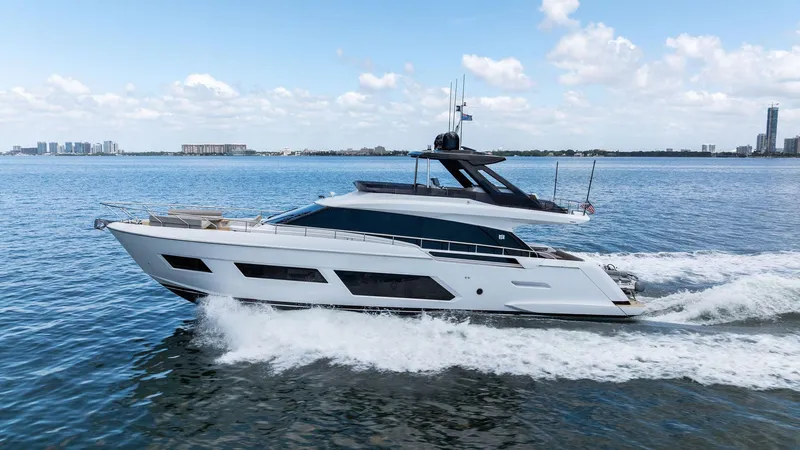 Giulia Yacht Photos Pics 2023 Ferretti Yachts 670 cruising on open water under a clear blue sky.