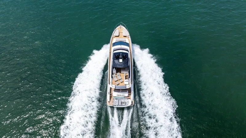 Giulia Yacht Photos Pics 2023 Ferretti Yachts 670 cruising on open water, aerial view.