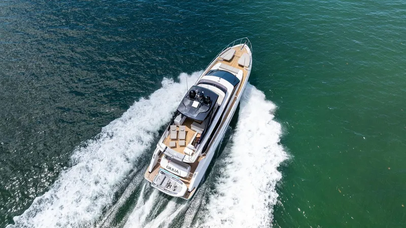 Giulia Yacht Photos Pics 2023 Ferretti Yachts 670 cruising on open water, aerial view.