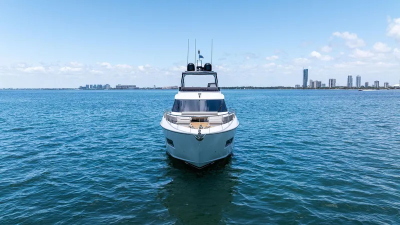 Giulia Yacht Photos Pics 2023 Ferretti Yachts 670 on open water with city skyline in background.