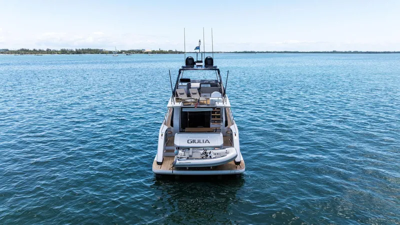 Giulia Yacht Photos Pics 2023 Ferretti Yachts 670 on calm water, rear view, luxury yacht.
