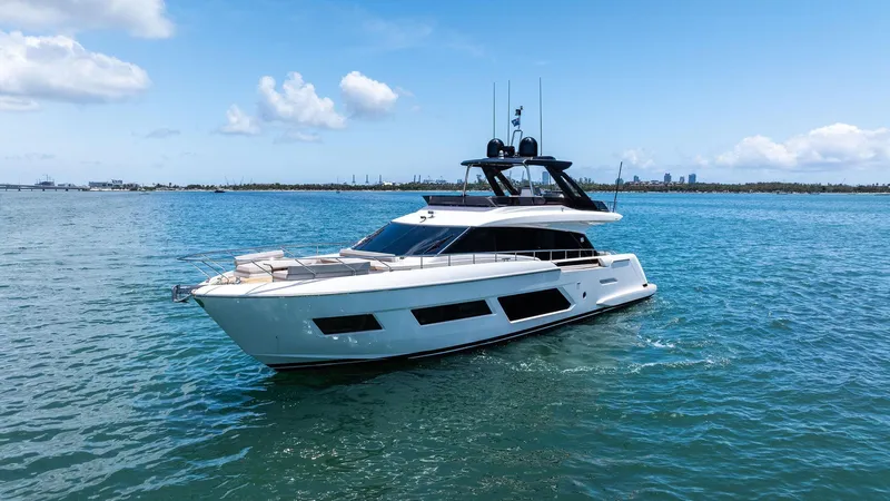 Giulia Yacht Photos Pics 2023 Ferretti Yachts 670 cruising on open water under a clear blue sky.