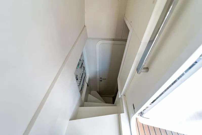 Giulia Yacht Photos Pics Staircase leading to a door inside a 2023 Ferretti Yachts 670.