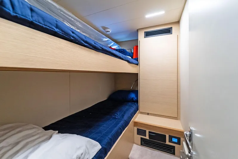 Giulia Yacht Photos Pics 2023 Ferretti Yachts 670 cabin with bunk beds, modern design, and blue bedding.