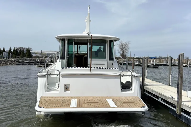  Yacht Photos Pics 2025 Sabre 45 Salon Express yacht docked at marina, rear view.
