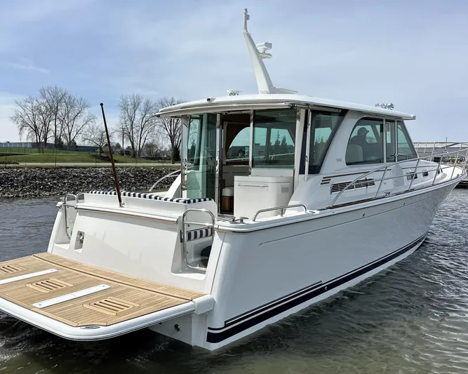  Yacht Photos Pics 2025 Sabre 45 Salon Express yacht on water, rear view, sleek design.