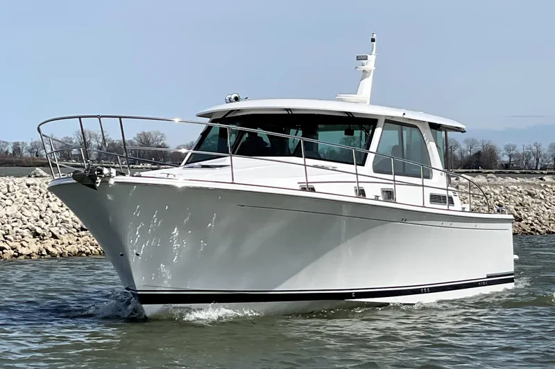  Yacht Photos Pics 2025 Sabre 45 Salon Express cruising on water, sleek white design.