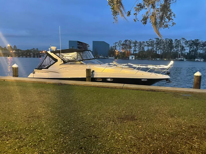 Cary'd Away Yacht Photos Pics 2005 Regal Commodore 3560 IB yacht docked at a serene waterfront during dusk.